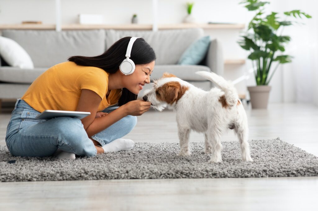 Emotional japanese woman cuddling with her pet at home