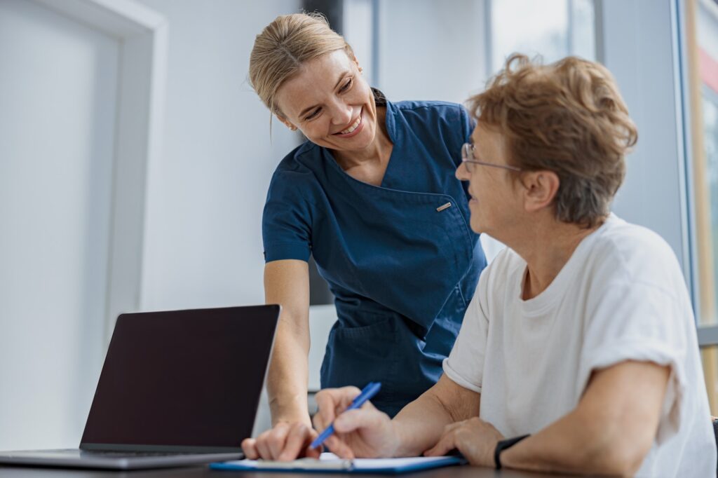 Female patient filling insurance legal document at appointment with doctor in clinic