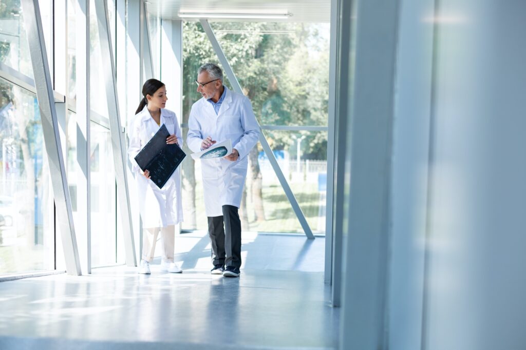 Professional medical worker talking to his assistant