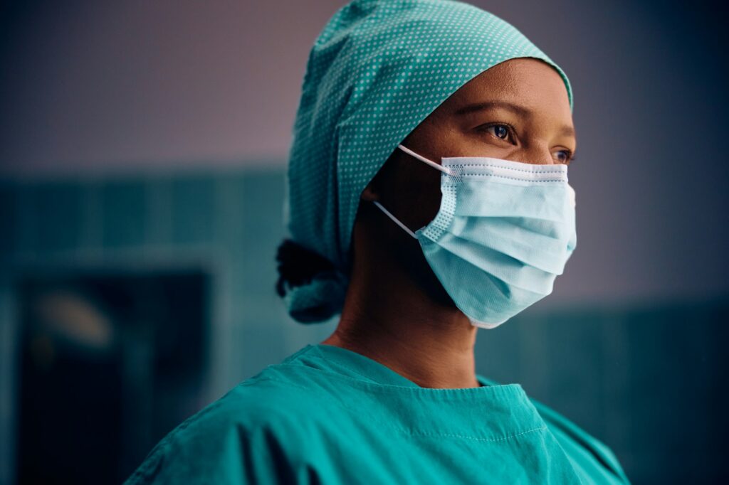 Thoughtful black female surgeon in the hospital.