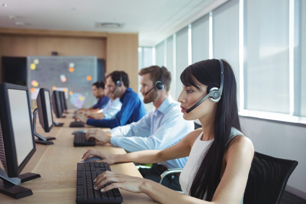 Businesswoman typing on keyboard at call center