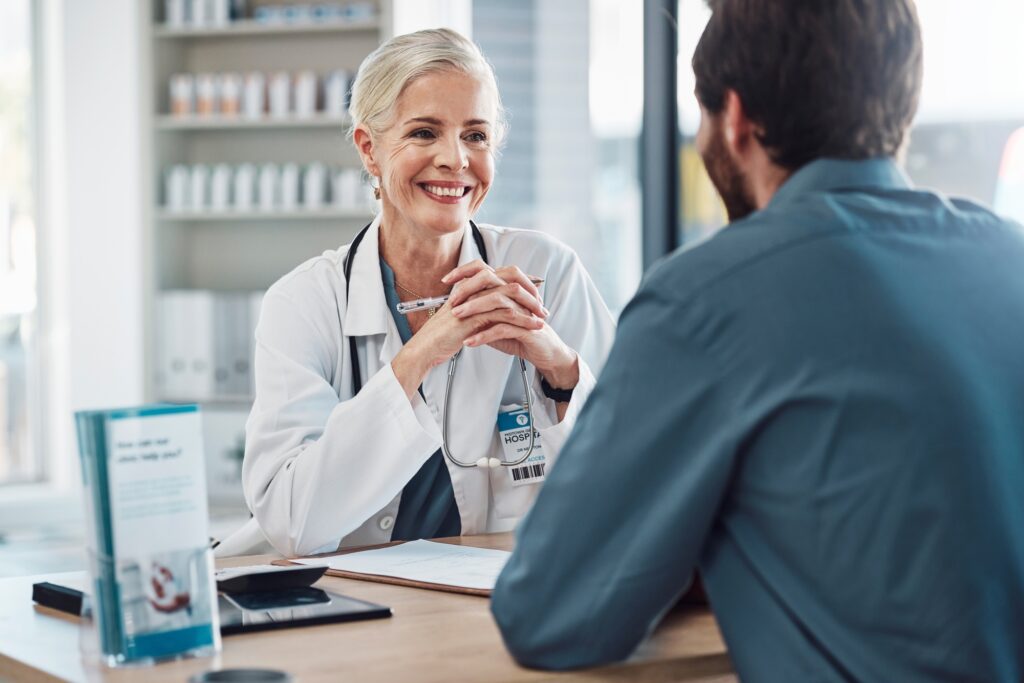 Consultation, doctor and patient talking with woman in hospital for doctors appointment. Healthcare