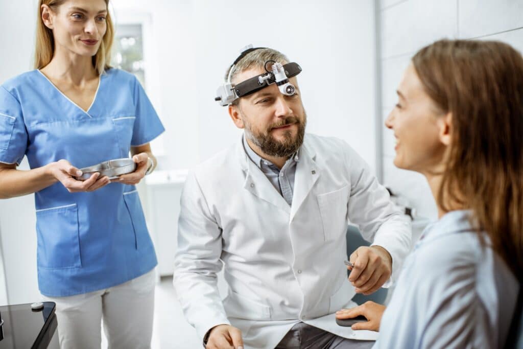 Patient with doctors in ENT office