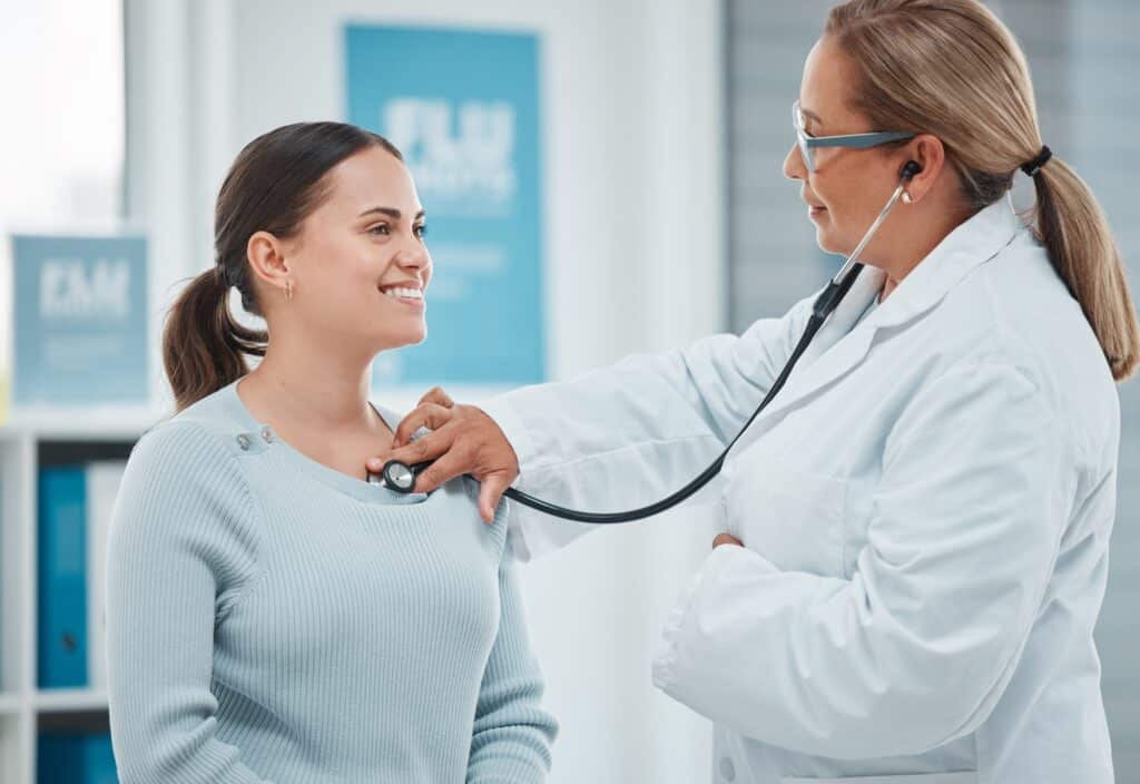 Shot of a doctor examining a patient with a stethoscope during a consultation in a clinic