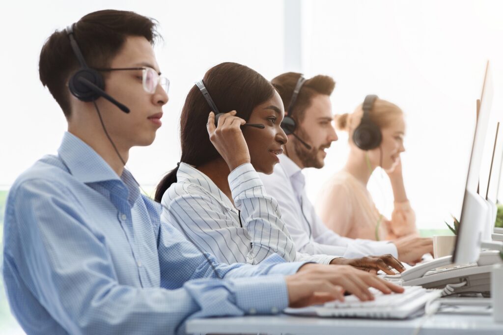 Telemarketing or customer service team providing assistance to clients at call centre office