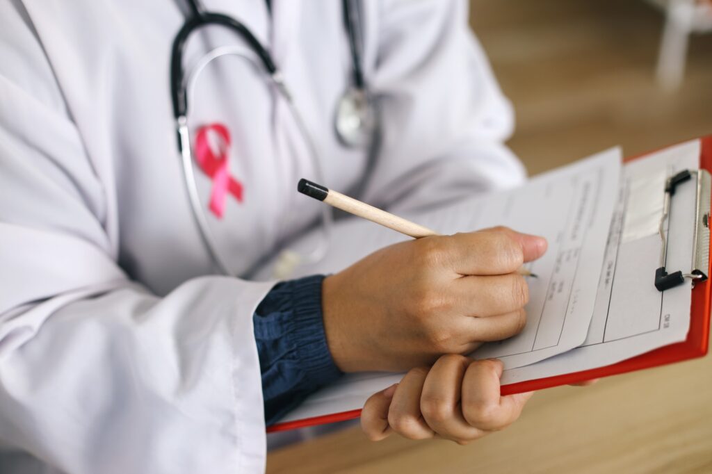 Doctor With White Uniform Writting Clipboard
